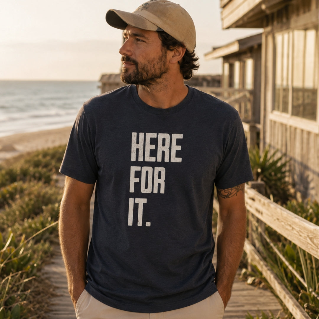 Dad wearing the Charcoal Here For It Tee on a beach boardwalk — EvoDad Co.